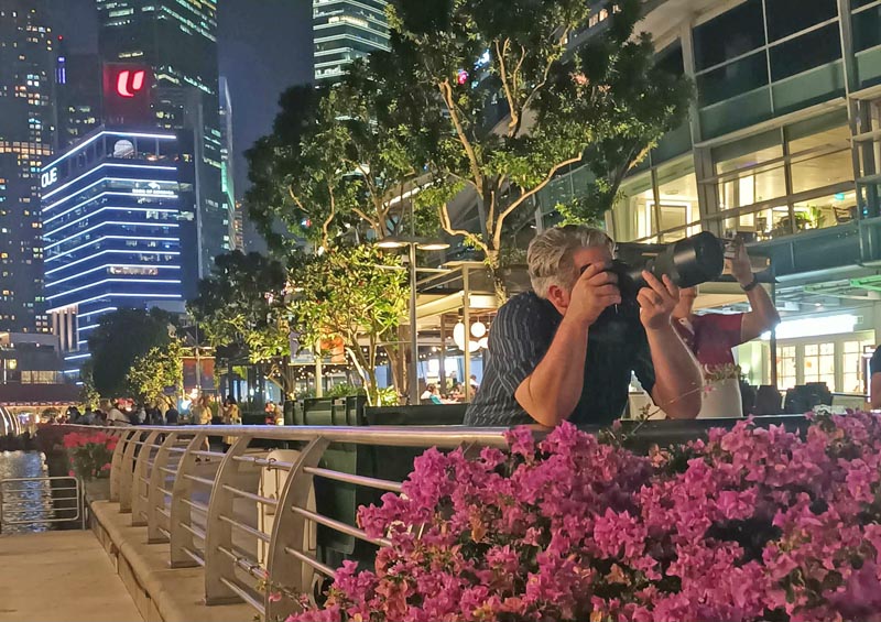 Neil Wallace in Singapore at night, taking photos